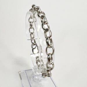 Silver chain bracelet on clear stand.