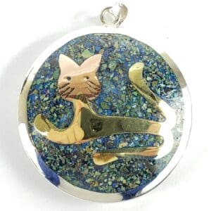 Cat pendant with blue speckled background.