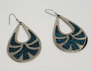 Silver teardrop earrings with blue patterns.