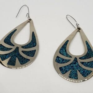 Silver teardrop earrings with blue inlay.
