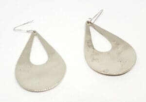 Silver teardrop-shaped earrings on white background.