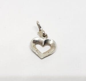 Silver heart-shaped pendant on white background.