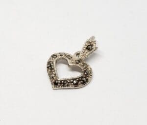 Heart-shaped pendant with intricate detailing.