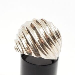 Silver spiral ring on black display stand.