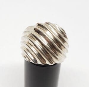 Silver textured pen cap on black base.