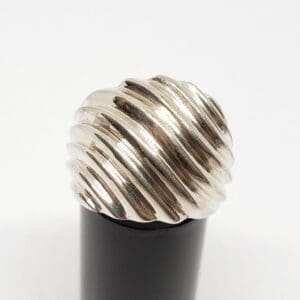 Silver textured pen cap on black base.