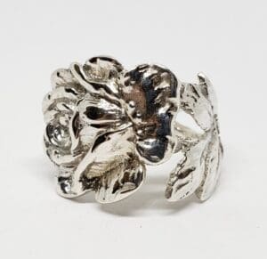 Silver floral ring with intricate detailing.