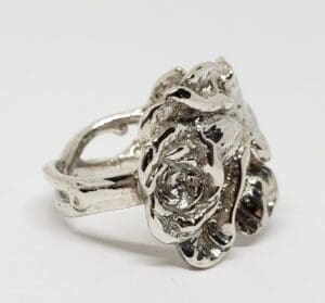 Silver ring with intricate rose design.