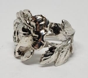 Silver ring with floral and leaf design.