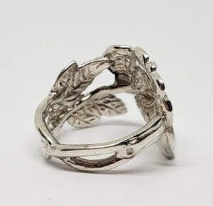 Silver ring with leaf design details.