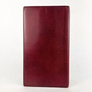 Red textured leather notebook cover.