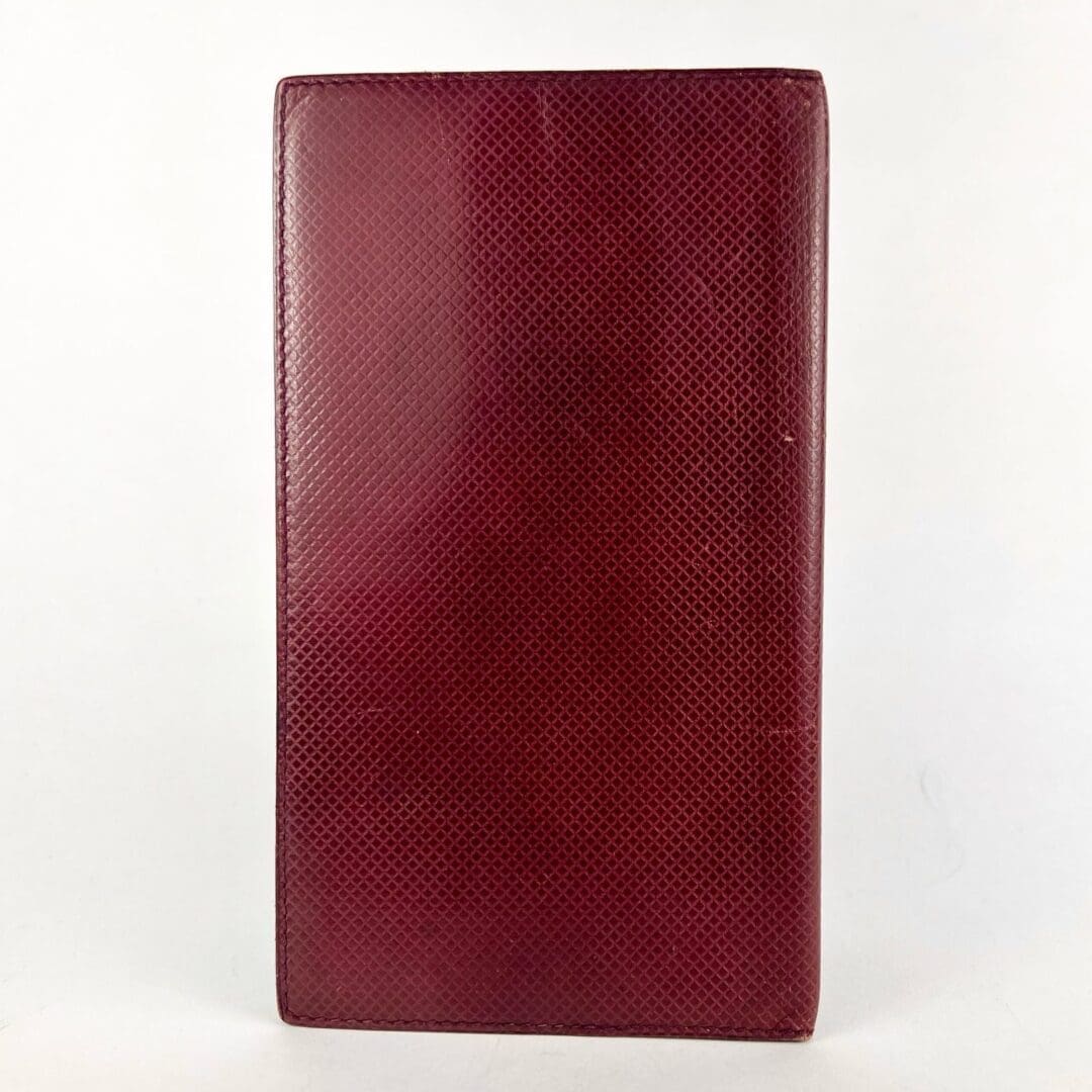 Red textured leather notebook cover.