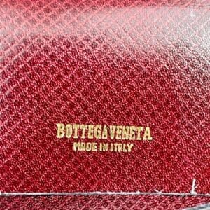 Red leather with Bottega Veneta branding.