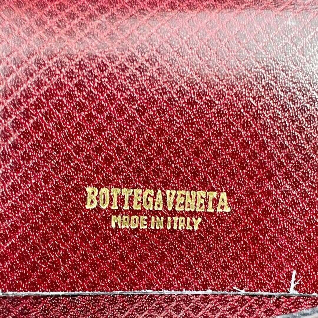 Red leather with Bottega Veneta branding.