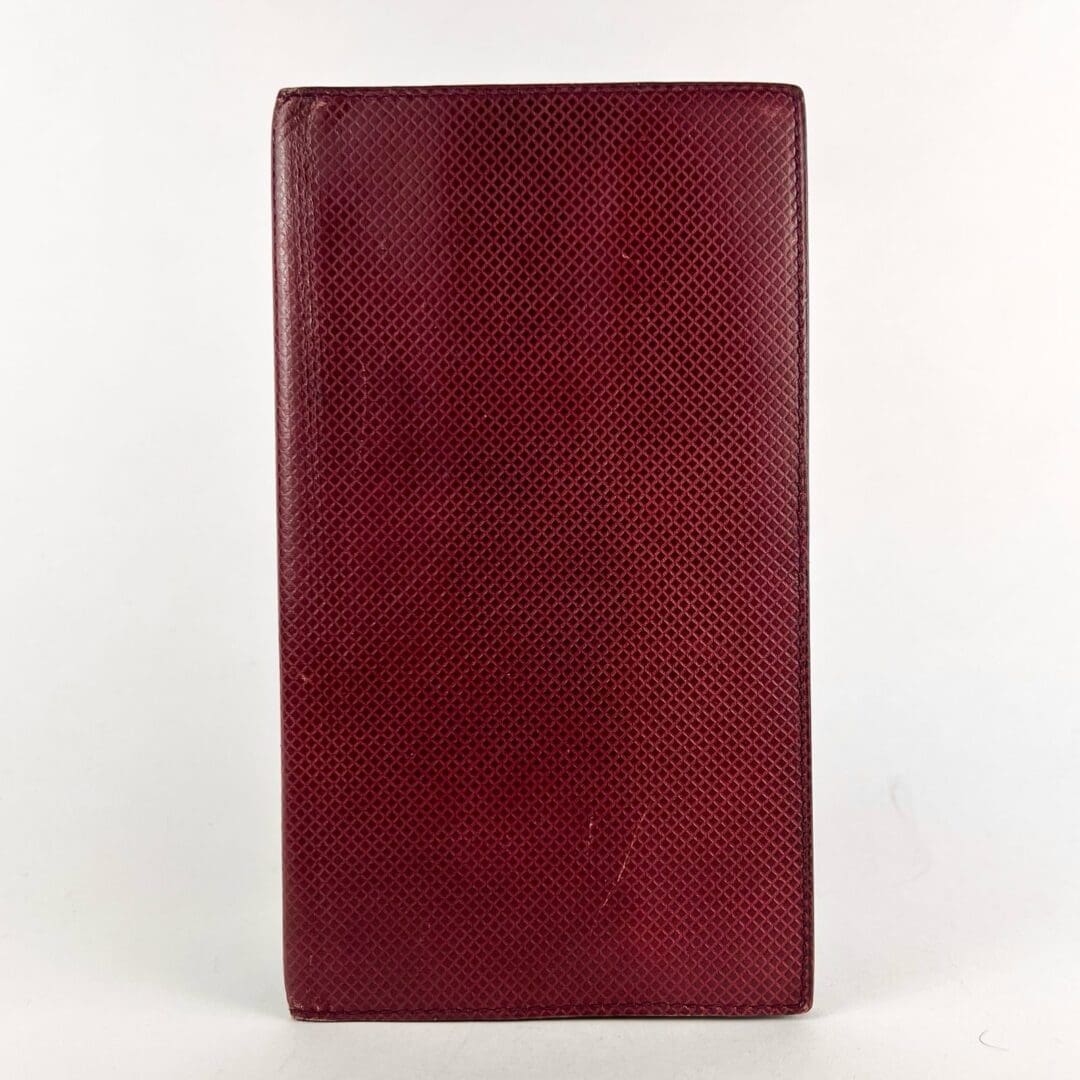 Red textured leather-bound book cover.