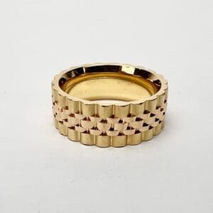 Gold textured ring on white background.