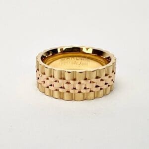 Gold textured ring on white background.