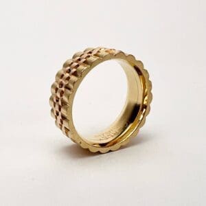 Gold ring with textured design.