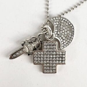 Silver necklace with cross and sword pendants.