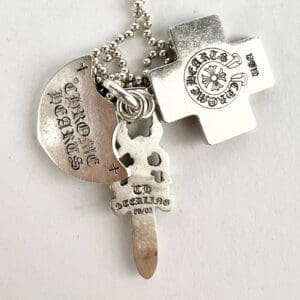 Silver keychain with cross and shield.