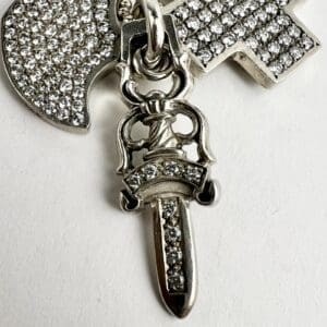 Diamond-encrusted axe and sword pendant.