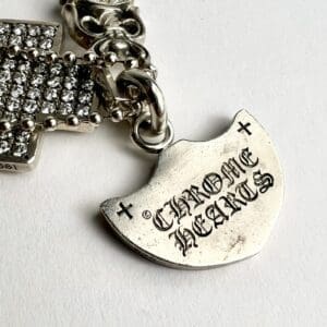 Silver jewelry with "Chrome Hearts" engraving.