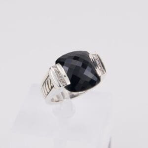 Silver ring with large black gemstone.
