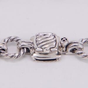 Silver chain bracelet with clasp detail.