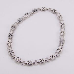 Silver bracelet with skull-shaped links.
