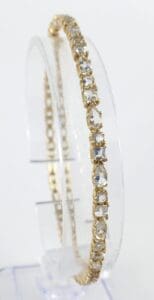 Gold bracelet with clear gemstone accents.