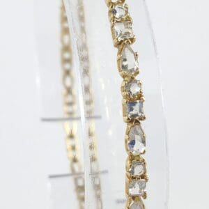 Gold bracelet with clear gemstone accents.