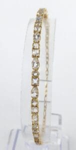 Gold bracelet with square-cut gemstones.