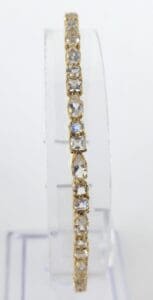 Gold bracelet with square diamond settings.