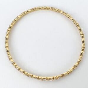 Gold bracelet with intricate geometric design.