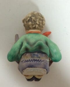Back view of a figurine with text.