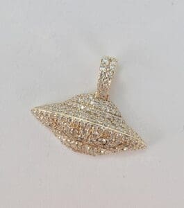 Diamond-studded UFO-shaped pendant on display.