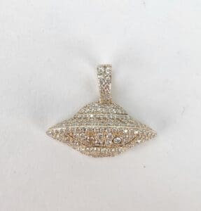 Gold UFO-shaped pendant with sparkling stones.