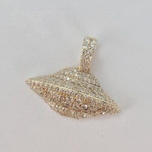 Diamond-studded UFO-shaped pendant on display.