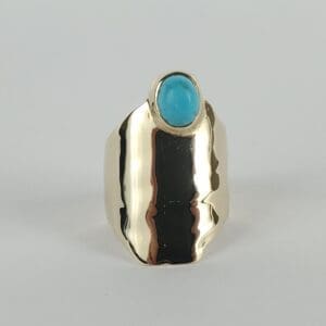 Gold ring with blue stone setting.