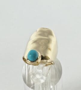 Gold ring with a blue stone centerpiece.