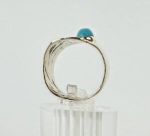 Gold ring with a turquoise gemstone.