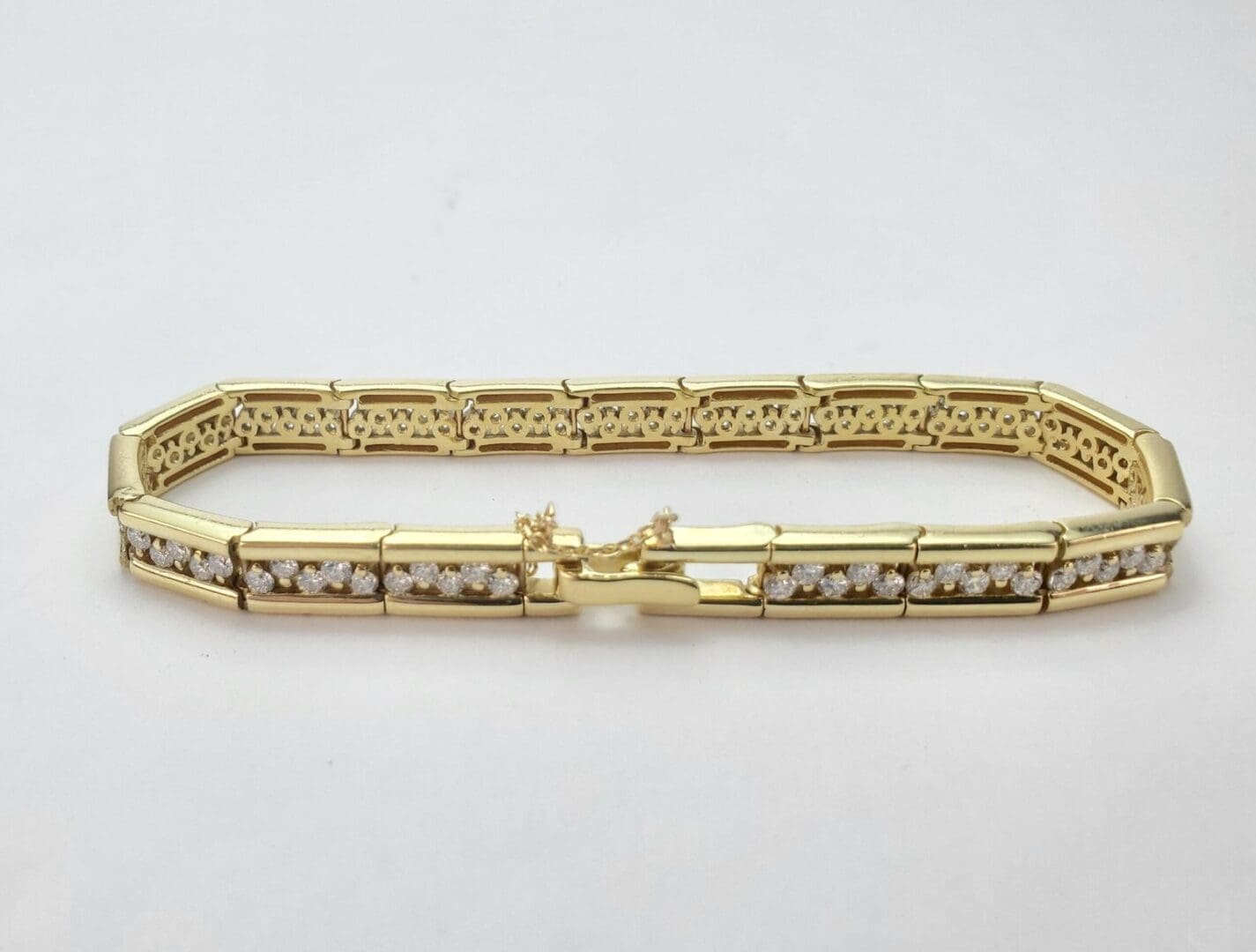 Gold bracelet with diamond accents.