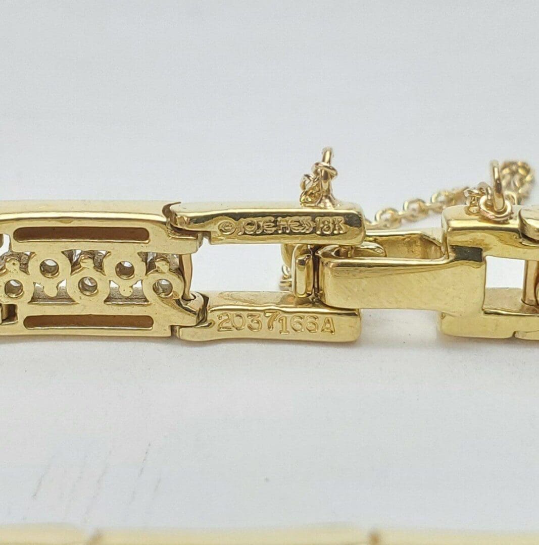 Gold bracelet with intricate rectangular links.