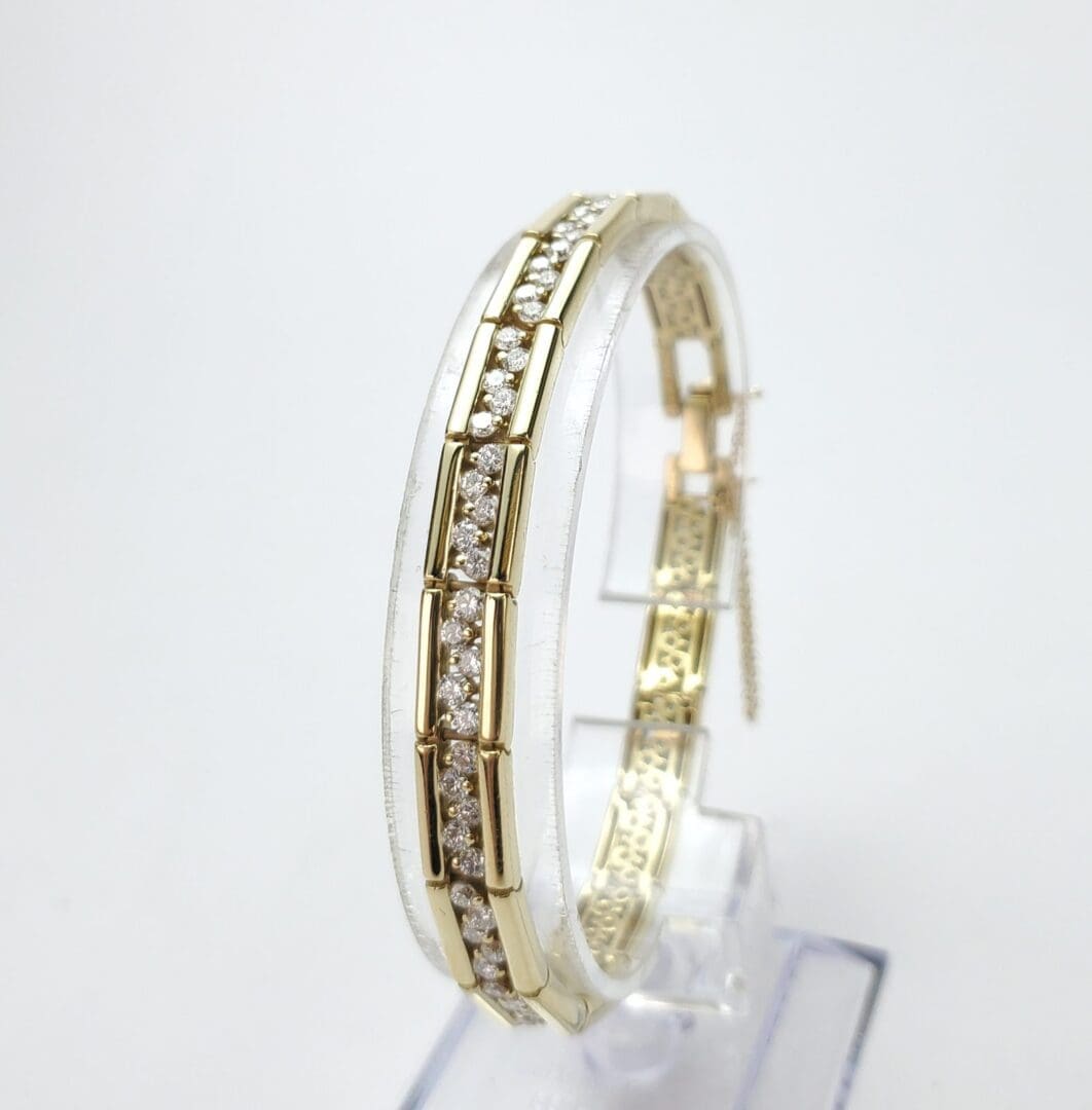 Gold bracelet with embedded diamond stones.