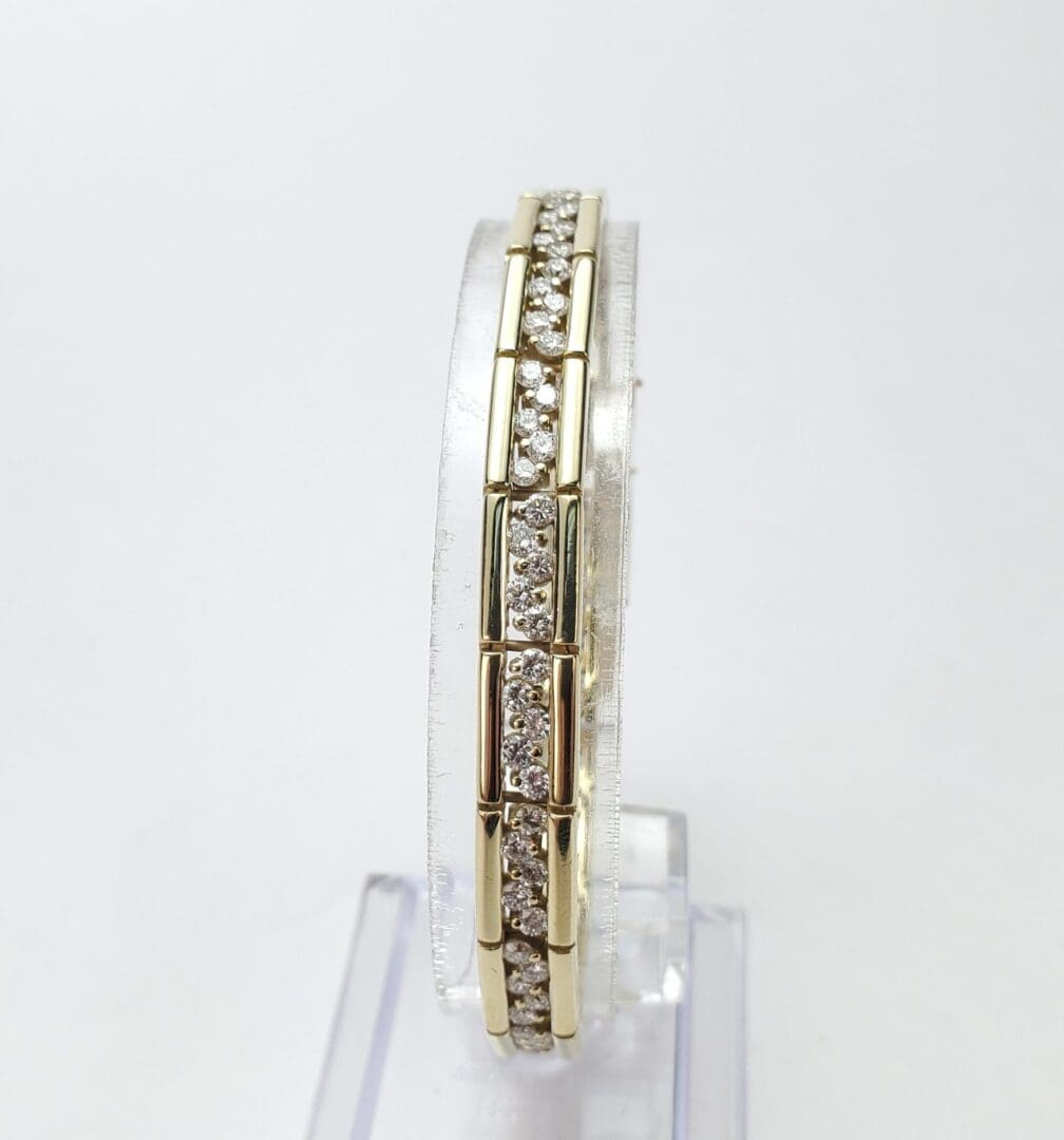 Gold bracelet with embedded diamonds on display.