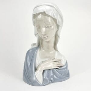 Ceramic bust of a serene, veiled woman.