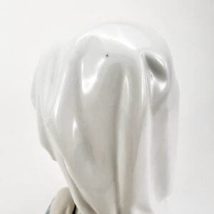 White, shiny dog sculpture from behind.