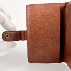 Brown leather wallet with snap closure.