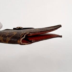 Worn wallet with brown textured surface.