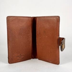 Open brown leather wallet, snap closure.